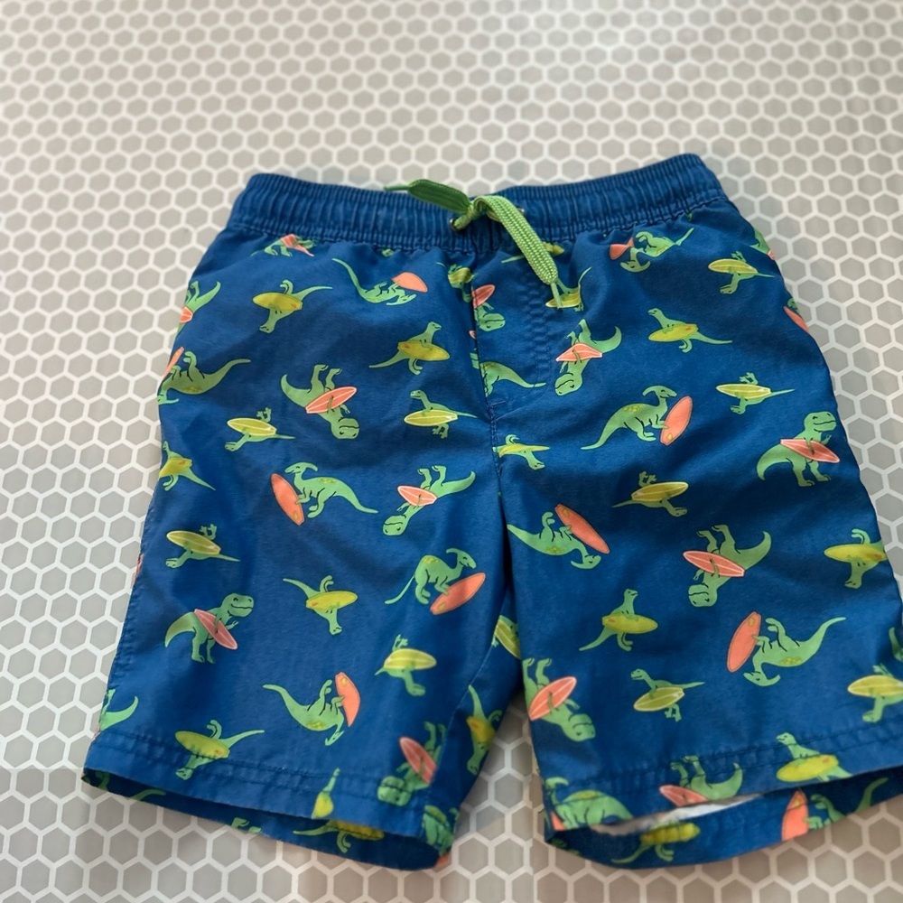 Carter's Blue Swim Shorts with Green Dinosaurs & Orange Surfboards.   Size 5T